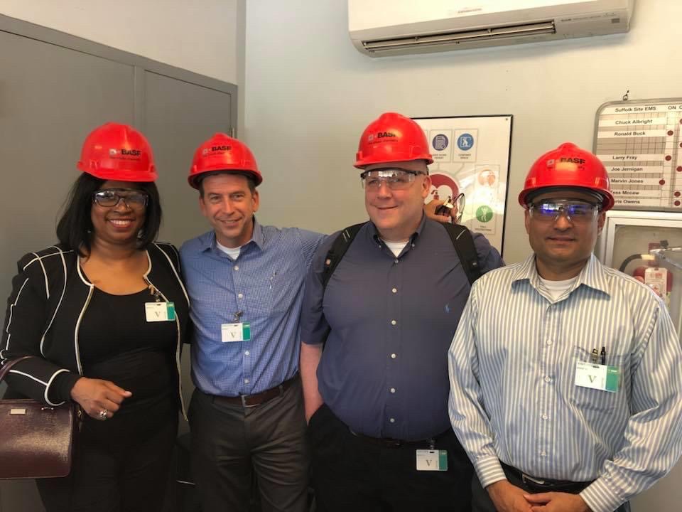 Darla Wolfe with colleagues wearing safety helmets during an industrial site visit